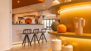 A modern interior with a bar area, bar stools, and decorative items on shelves. - BELSTAY ROMA AURELIA (Rome)