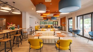 A modern dining area with high ceilings, pendant lighting, and a central seating area. - BELSTAY ROMA AURELIA (Rome)