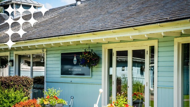 A building with a sign reading "The Boathouse on Loch Lomond."
