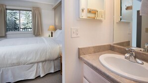 Une chambre d’hôtel avec un lit, une salle de bain comprenant un lavabo et un miroir, et une fenêtre avec des rideaux.