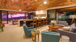 A modern interior with a wooden ceiling, a dining area, a kitchen, and a seating area with a view of the outdoors. - 3BR Ocean & Mountain View Escape, Short Drive to the Beach! (Uvita)