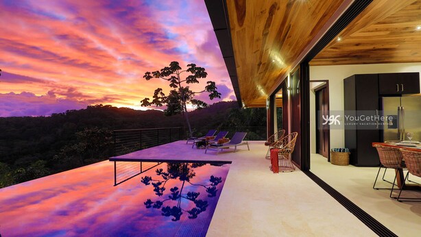 A modern outdoor pool area with a sunset view, lounge chairs, and a dining area with a view. - 3BR Ocean & Mountain View Escape, Short Drive to the Beach! (Uvita)