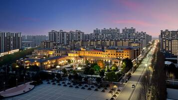 A high-rise hotel complex with multiple buildings, a central courtyard, and a well-lit street.