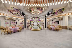 A spacious banquet hall with multiple round tables, elegant chandeliers, and floral decorations.
