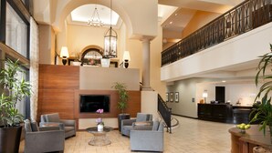 A spacious lobby with a high ceiling, a grand staircase, and a reception desk. - The Westin Mission Hills Resort Villas, Palm Springs (Rancho Mirage)