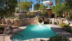 A pool area with a water slide, rock formations, and palm trees. - The Westin Mission Hills Resort Villas, Palm Springs (Rancho Mirage)