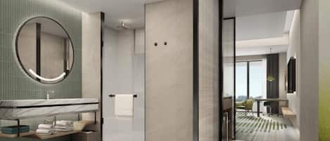 A modern bathroom with a large mirror, a shower, and a vanity with a towel rack.