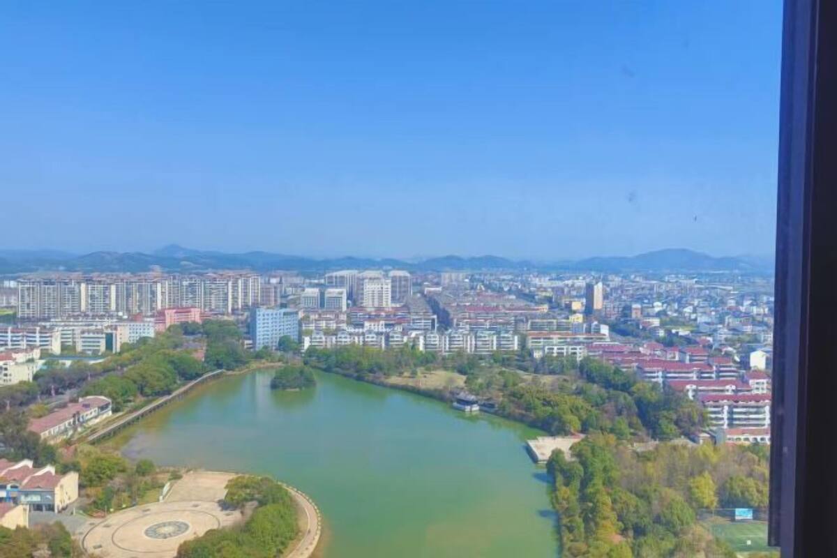 A cityscape with a river, buildings, and a clear sky.