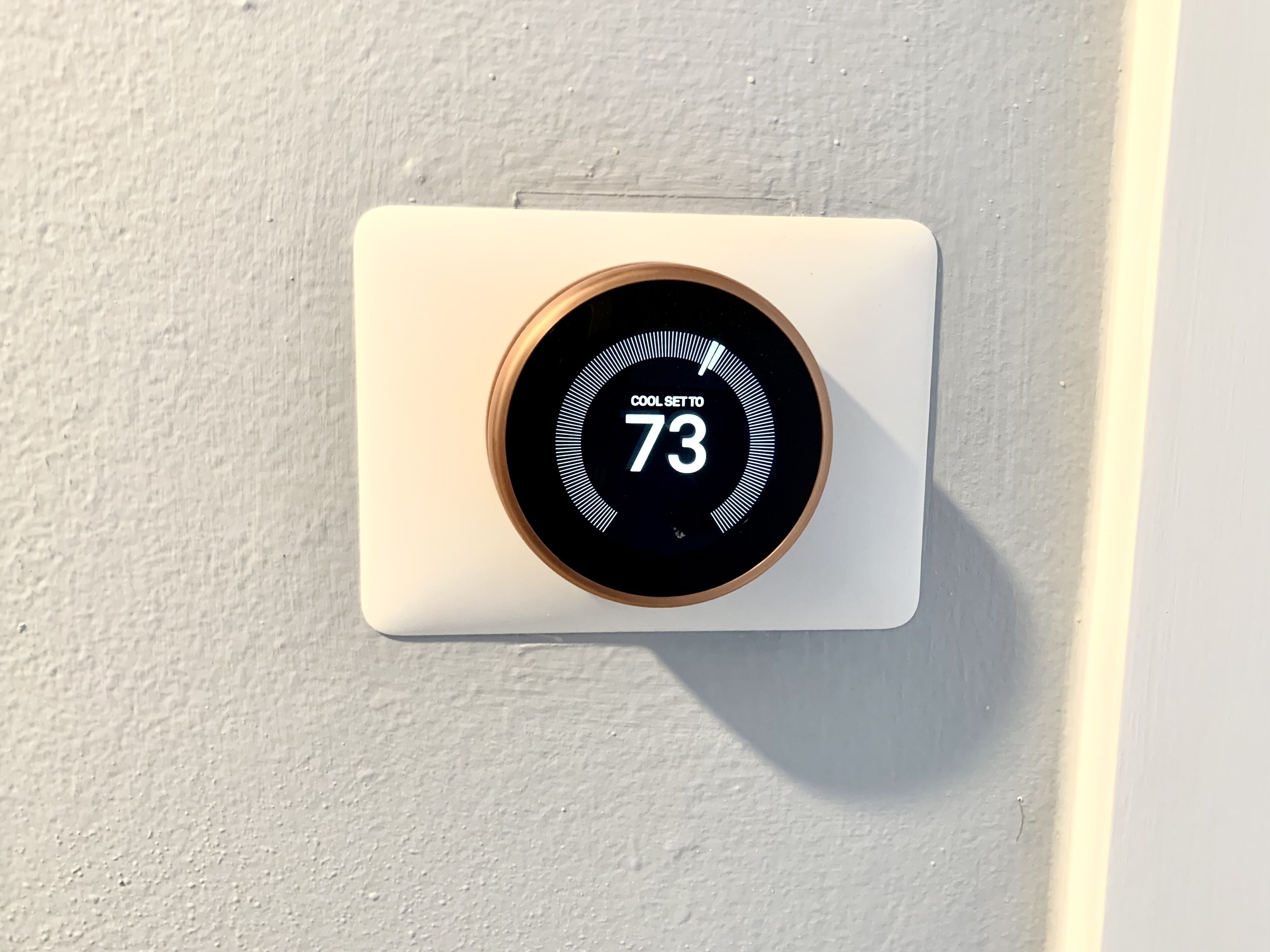 A thermostat set to 73 degrees Fahrenheit.