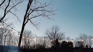 An outdoor patio with a fire pit, wooden chairs, and a table set for dining. - Peaceful Light-Filled Guesthouse salt pool/sauna - 1 Hour From NYC (Pound Ridge)