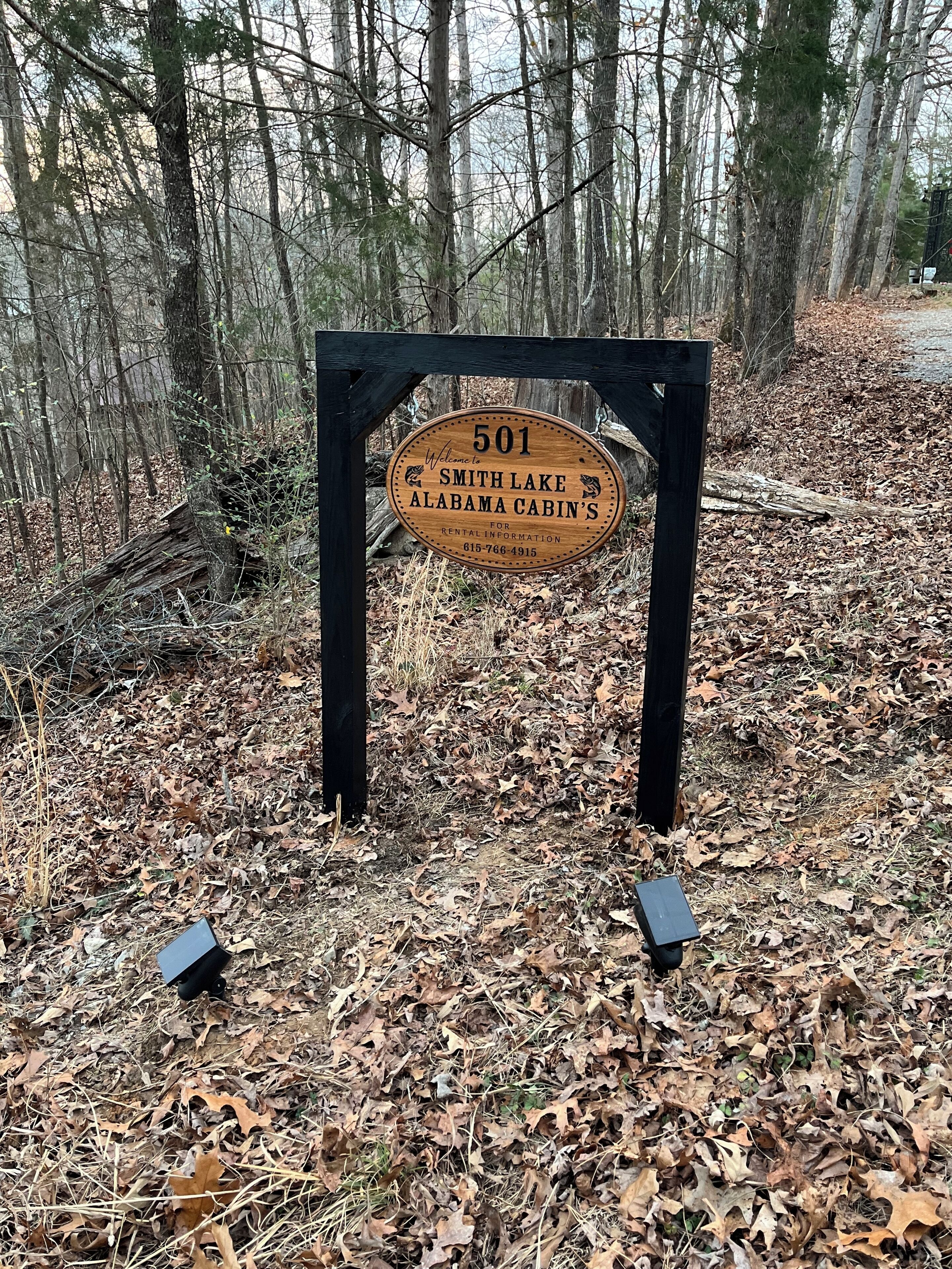 A wooden sign for Smith Lake Alabama Cabin's, number 501, indicating it is a rental property.