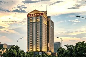 Un edificio de hotel alto con una entrada destacada y un cielo despejado al fondo.