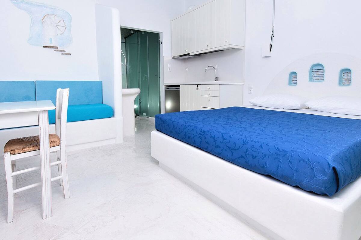 A modern bedroom with a bed, a desk, and a chair.