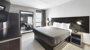 A modern hotel room with a large bed, bedside table, and a TV. - Casa Azul Hotel Blu JFK (Queens Village)