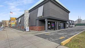A hotel with a modern facade, an ATM, and a visible entrance. - Casa Azul Hotel Blu JFK (Queens Village)