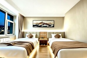A hotel room with two beds, a nightstand, a painting, and a view of the city at night.