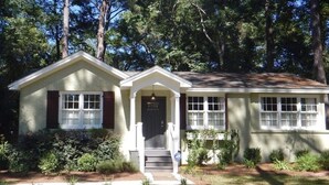 A single-story house with a front porch, a small front yard, and a mailbox.