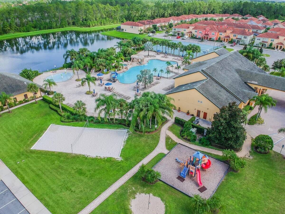 A resort with a swimming pool, a children's play area, and a tennis court.