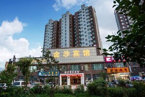 A multi-story building with a prominent sign for a restaurant.