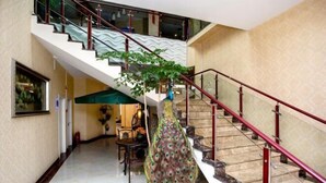 A staircase with red railings and a peacock feather decoration. - Changchun Jinsha Hotel (Changchun)