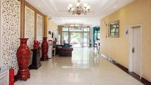 A spacious lobby with a polished floor, decorative vases, and a chandelier. - Changchun Jinsha Hotel (Changchun)