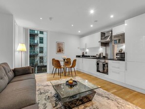 A modern apartment with a living area, dining space, and kitchen.