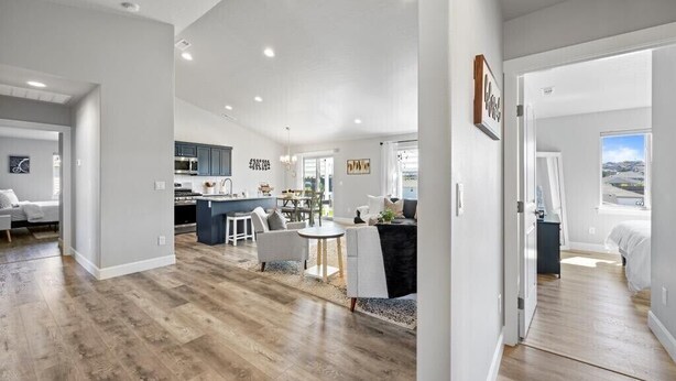 A spacious living area with a kitchen, dining area, and a bedroom with a view. - New house!! Outdoor Hot tub with beautiful sunset views (Kennewick)