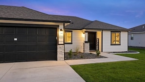 A modern two-story house with a garage, a well-maintained lawn, and a welcoming entrance. - New house!! Outdoor Hot tub with beautiful sunset views (Kennewick)