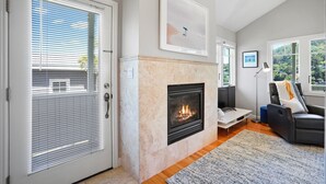 A living room with a fireplace, a sofa, and a coffee table.