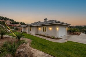 A modern two-story house with a tiled roof, a garage, and a well-maintained lawn. - Stunning 3 bedroom with Pool/Hot Tub/Game Room (Escondido)