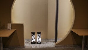 A circular architectural feature with two cylindrical objects at its base, possibly decorative or functional elements. - HOTEL GLANY's KOSHIGAYA premier (Koshigaya)