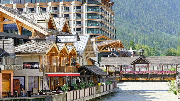A hotel with multiple balconies, wooden architecture, and a river view. - Apt CourmayeurC44 w/MontBlanc view Parking, Chamonix, France (Chamonix)