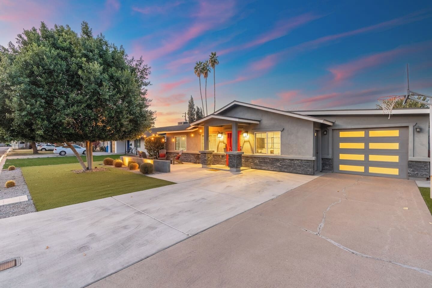 A modern two-story house with a garage, a driveway, and a well-maintained lawn.