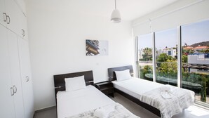 A hotel room with two beds, a large window, and a view of the outside. - Protaras Holiday Villa Ccv2 (Protaras)