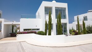 A modern white building with large windows and a pool area. - Protaras Holiday Villa Ccv2 (Protaras)