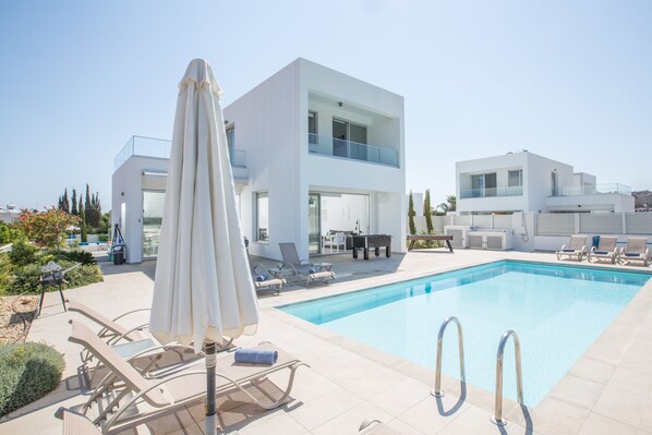 Relax by the pool surrounded by a spacious deck and lounge chairs, with breathtaking views of the surrounding landscape.