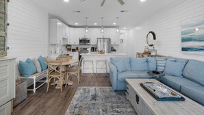 A modern kitchen with white cabinetry, a central island, and a ceiling fan. - Private Beach | 1 minute walk to Beach! | Beautifully updated 1 bedroom condo | Sleeps 6 | Wi-Fi (Santa Rosa Beach)