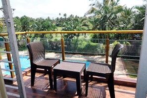 Deluxe Poolview | Living area - Nilaya Nest Away (Alibag)