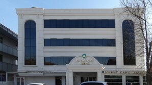 A white building with a sign for the Royal Sweet Hotel and Sweet Cafe Historic. - Royal Sweet Hotel (Ankara)