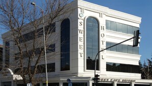 A hotel with a classic architectural style, featuring large arched windows and a prominent 'HOTEL' sign on the facade. - Royal Sweet Hotel (Ankara)
