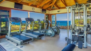A gym with treadmills, elliptical machines, and weight equipment, overlooking a scenic view. - 🏖️Garden View Waikoloa Condo w/ A/C + Ocean Club Access (Waikoloa)