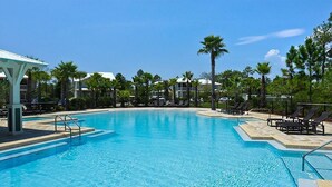 A large, clear swimming pool with lounge chairs and palm trees around it. - ☀️2 Masters~2 Golf Carts Included~6 Bikes~Pools~Last Call at NatureWalk 30A (Santa Rosa Beach)