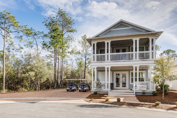A two-story house with a porch and a garage.