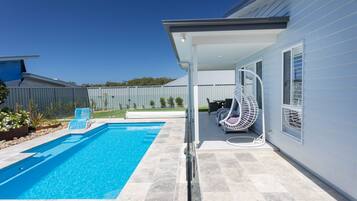 A heated pool, sun loungers