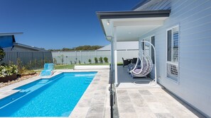 A heated pool, pool loungers