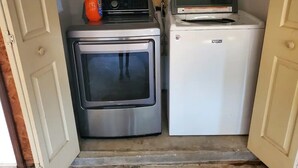 A compact kitchen with a stainless steel oven and a white refrigerator.