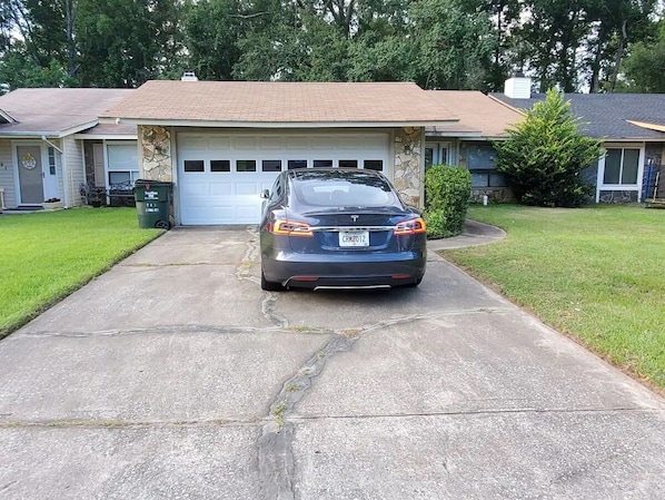 A residential garage with a car parked in front. - Beautifully design house for relaxation (Warner Robins)
