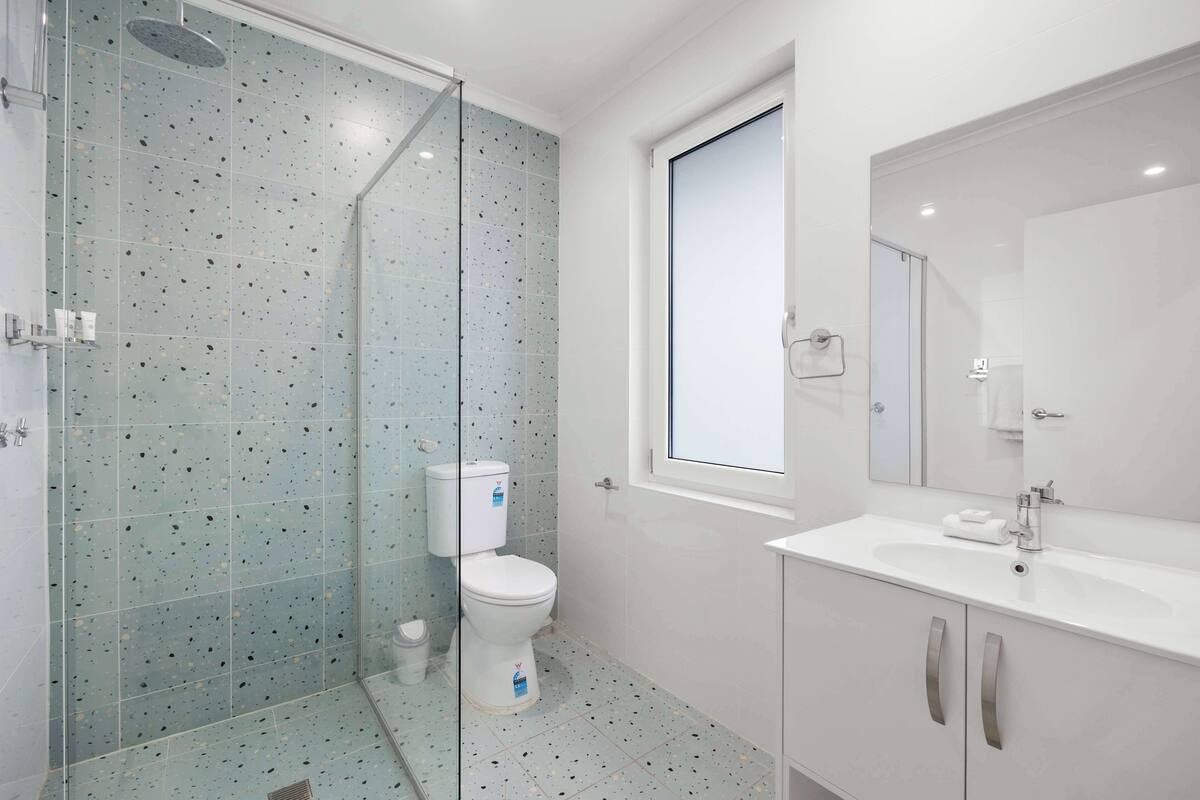 deluxe room, multiple beds | bathroom | shower, rainfall showerhead, hair dryer, towels