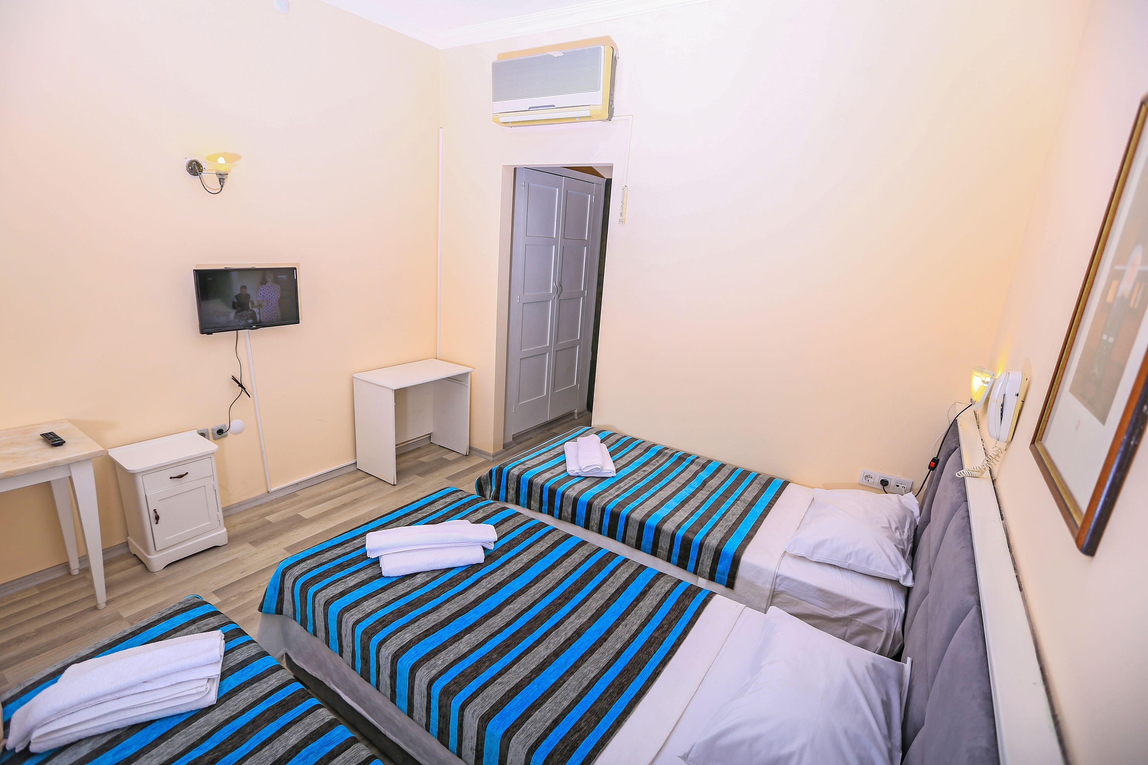 Standard Triple Room, Non Smoking, City View | Minibar, in-room safe, desk, laptop workspace