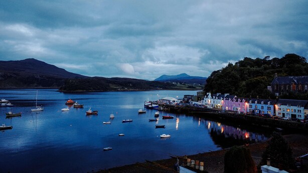 A harbor with boats, a dock, and buildings along the shore. - Isle of Skye Guest house (Kyleakin)
